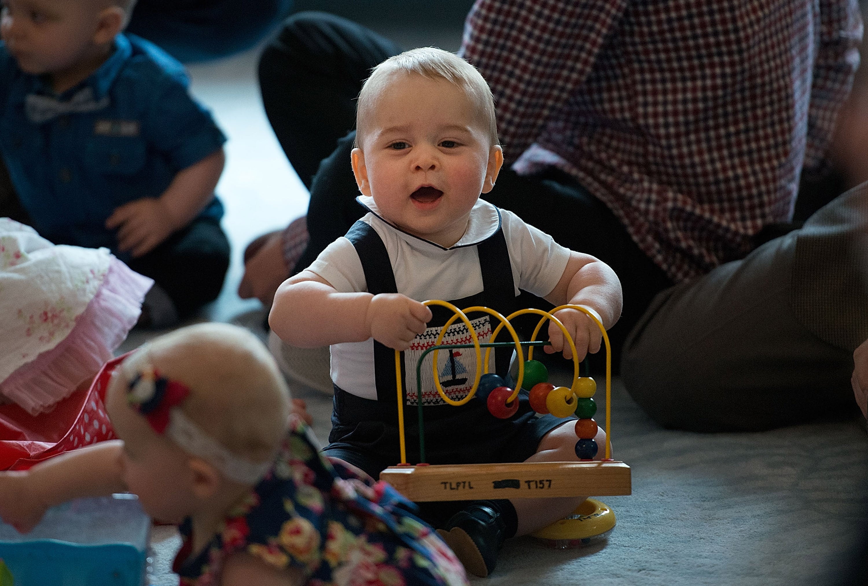 2014: Prince George of Cambridge plays during a Plunket nurse and parents group visit at Government House on April 9, 2014, in Wellington, New Zealand. Plunket is a national not-for-profit organization that provides care for children and families in New Zealand. The Duke and Duchess of Cambridge are on a three-week tour of Australia and New Zealand, the first official trip overseas with their son, Prince George of Cambridge.