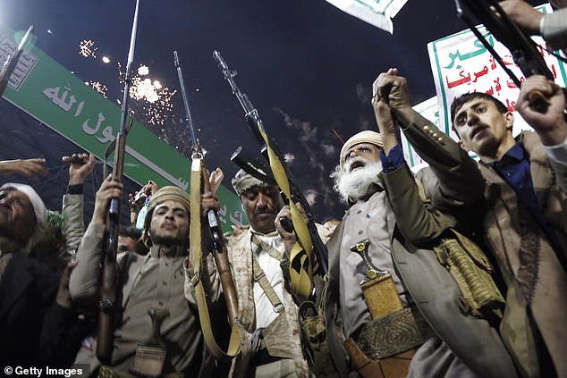 Protesters who support Yemen's Houthi group brandish weapons and shout slogans as they celebrate the ban decision imposed against the maritime shipping of Saudi Arabia on July 20, 2026 in Sana'a, Yemen