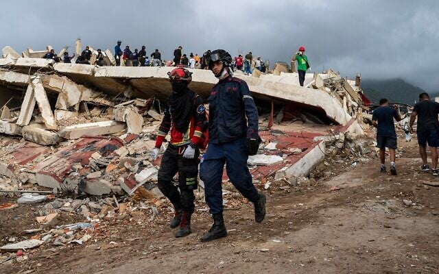 Volunteers and rescue members help to find survivors in Caraballeda, La Guaira state, Venezuela, on June 30, 2026, following the June 24 twin earthquakes. (Miguel Medina/Pool Photo via AP)