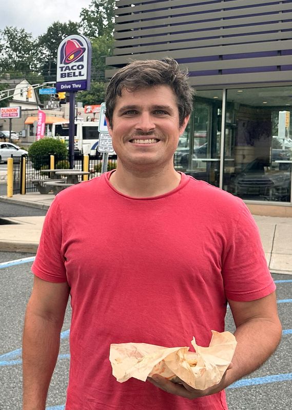 Shai Bialer stands outside a Taco Bell, in Orange