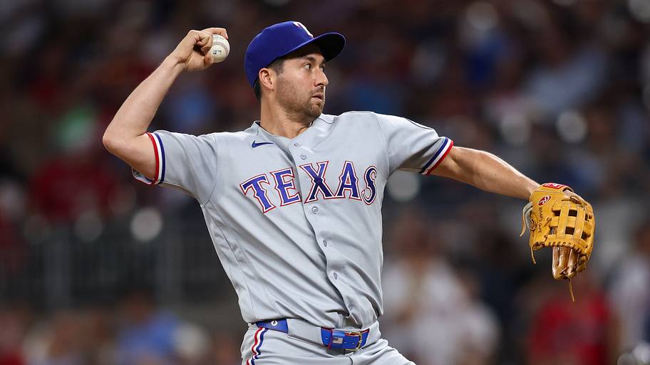 Texas Rangers catcher Kyle Higashioka throws a baseball as a pitcher.