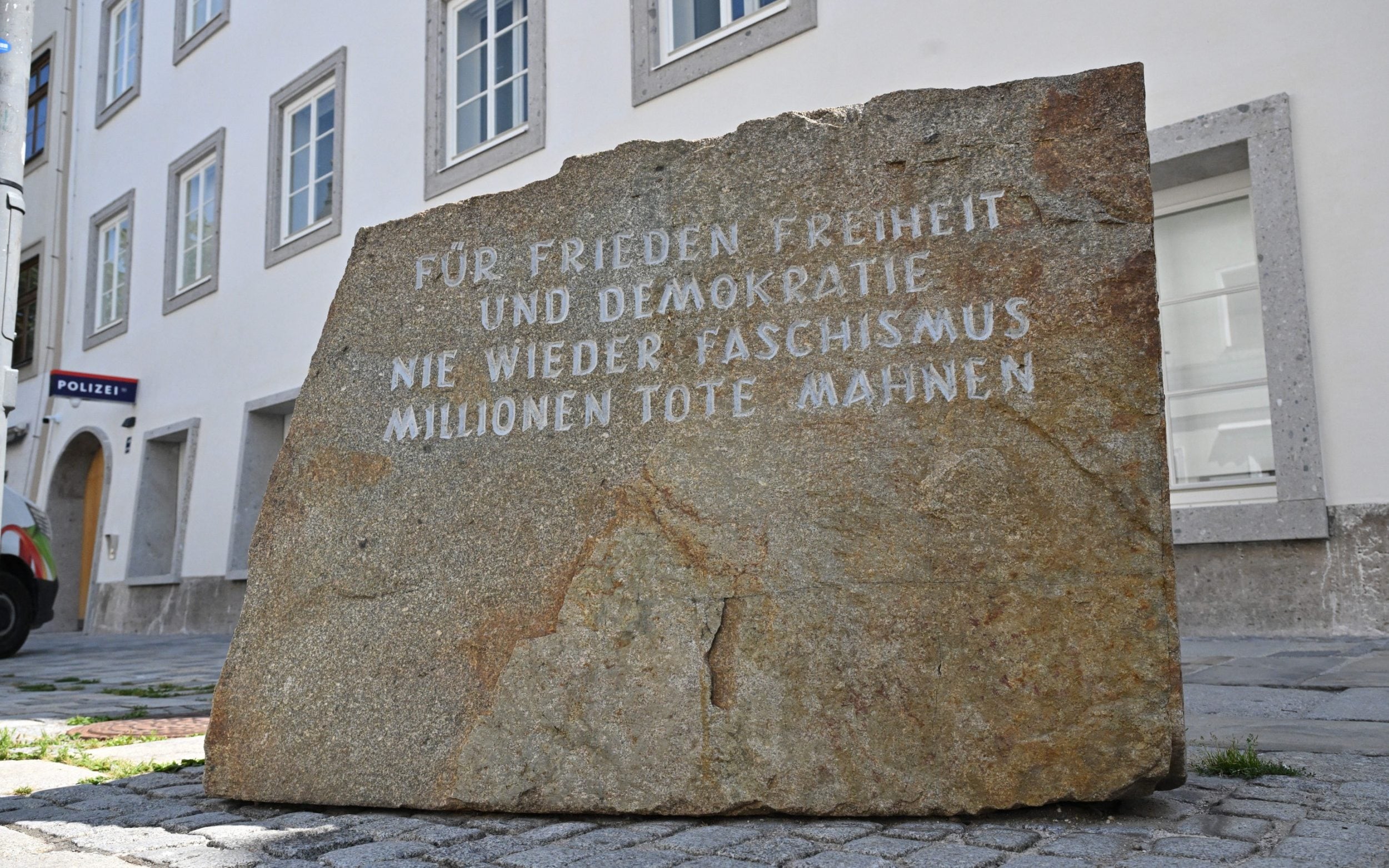 A memorial stone is located at the front of the police station