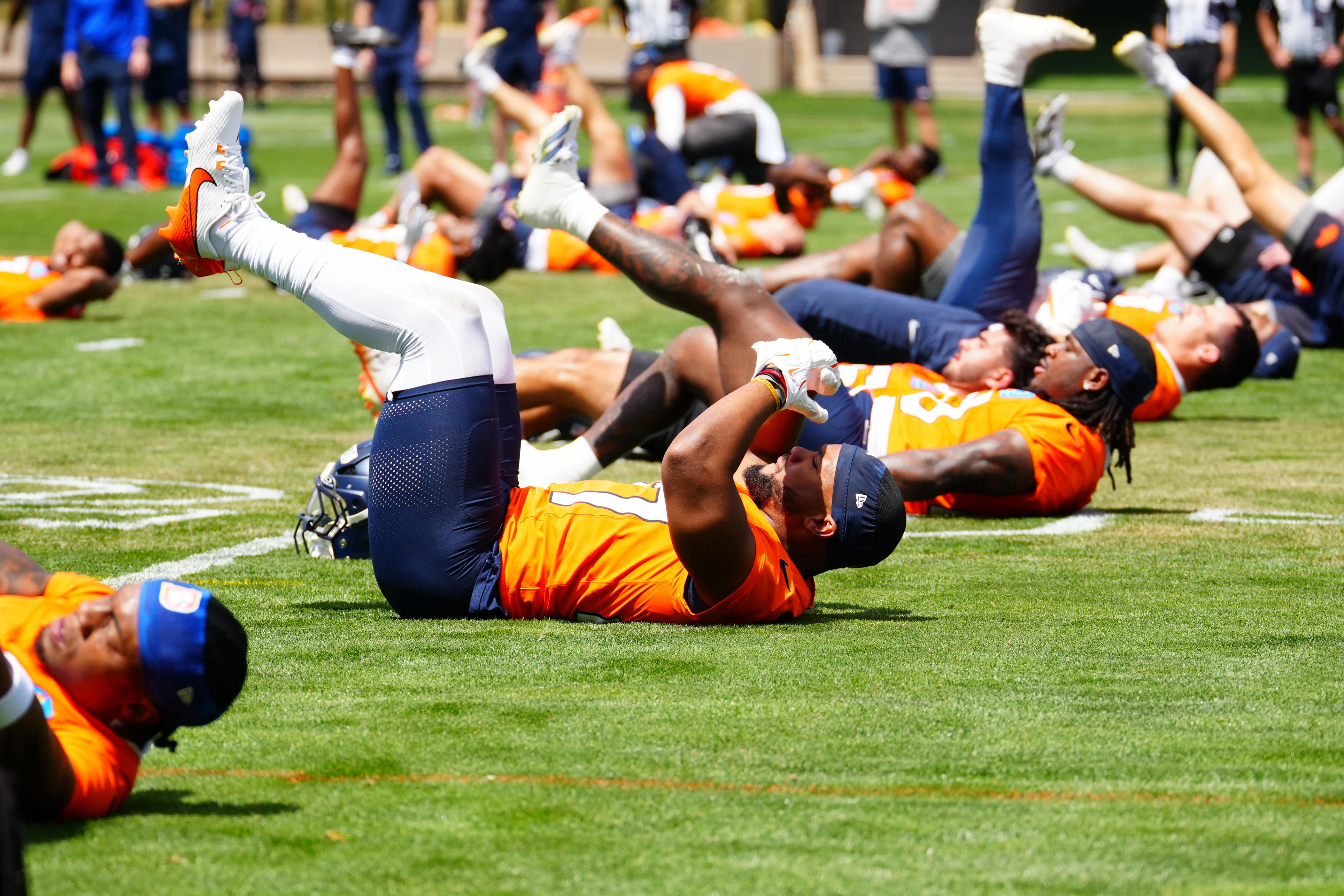 Jun 16, 2026; Englewood, CO, USA; Members of the Denver Broncos warm up before the start of mini camp at Broncos Park. Mandatory Credit: Ron Chenoy-Imagn Images