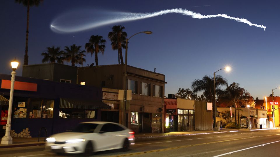 A SpaceX Falcon 9 rocket rises after launching from Vandenberg Space Force Base carrying 25 Starlink internet satellites, as seen from Pasadena, California, on April 6. - Mario Tama/Getty Images