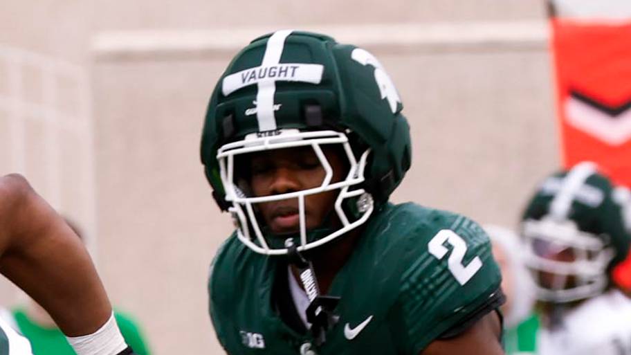 Michigan State running back Marvis Parrish (21) carries the ball as safety Devin Vaught (2) chases