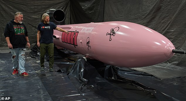 Prototypes were painted bright pink to make them easier to retrieve, earning them them their distinctive nickname. Pictured: Two members of a Czech endowment fund for Ukraine look at a Flamingo cruise missile at the Fire Point secret factory at an undisclosed location