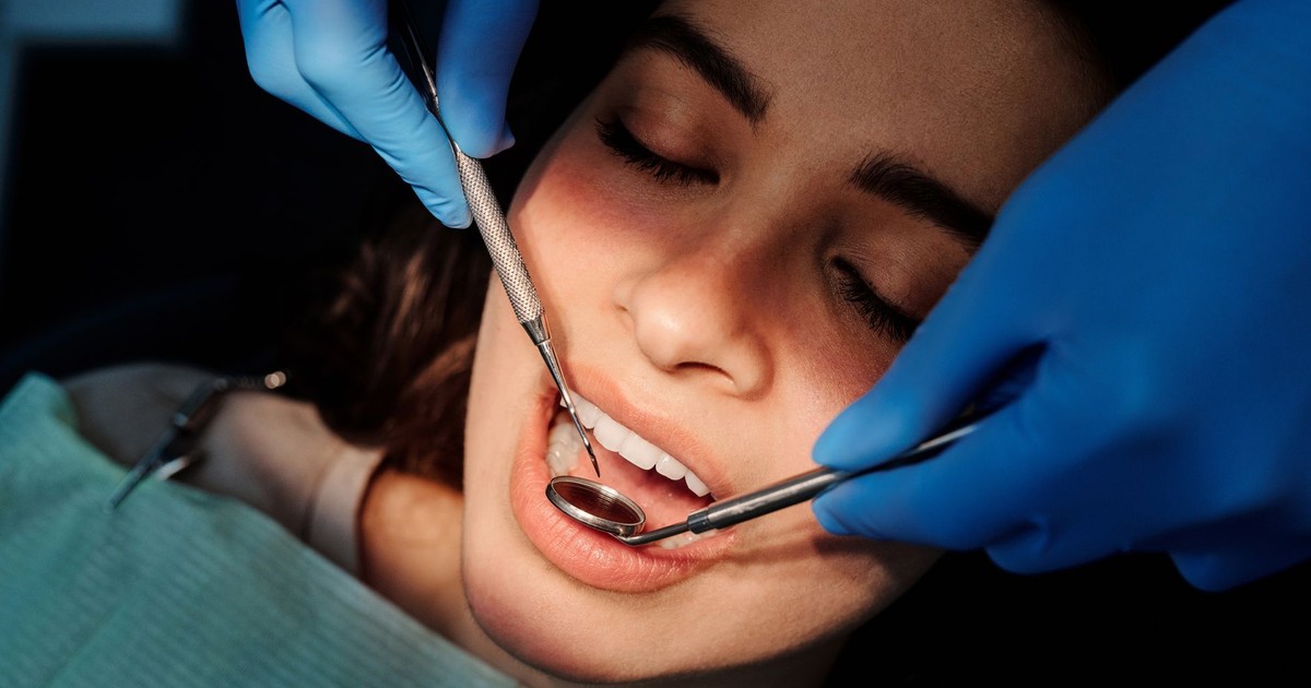 Close-up of a dental examination showing a woman patient receiving dental care from a professional.