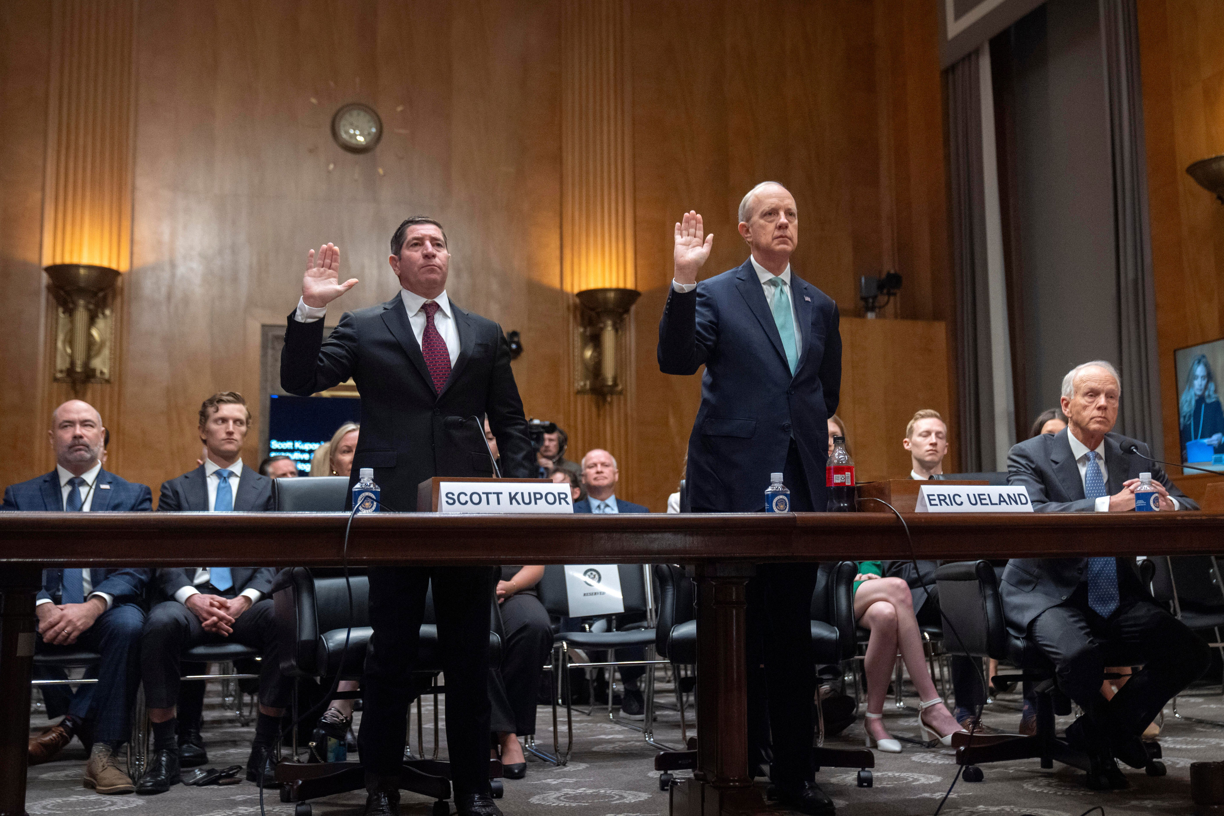 Scott Kupor, left, President Trump's pick to be director of the Office of Personnel Management, and deputy Eric Ueland, right, are sworn in during a Senate hearing on April 3, 2025. / Credit: Mark Schiefelbein / AP