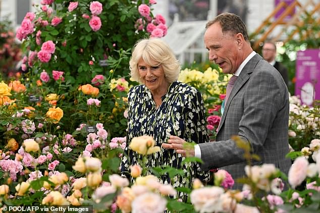 Gardeners' World star David J.C. Austin has died after being diagnosed with a neurological illness (pictured with Camilla at The Chelsea Flower Show in 2023)