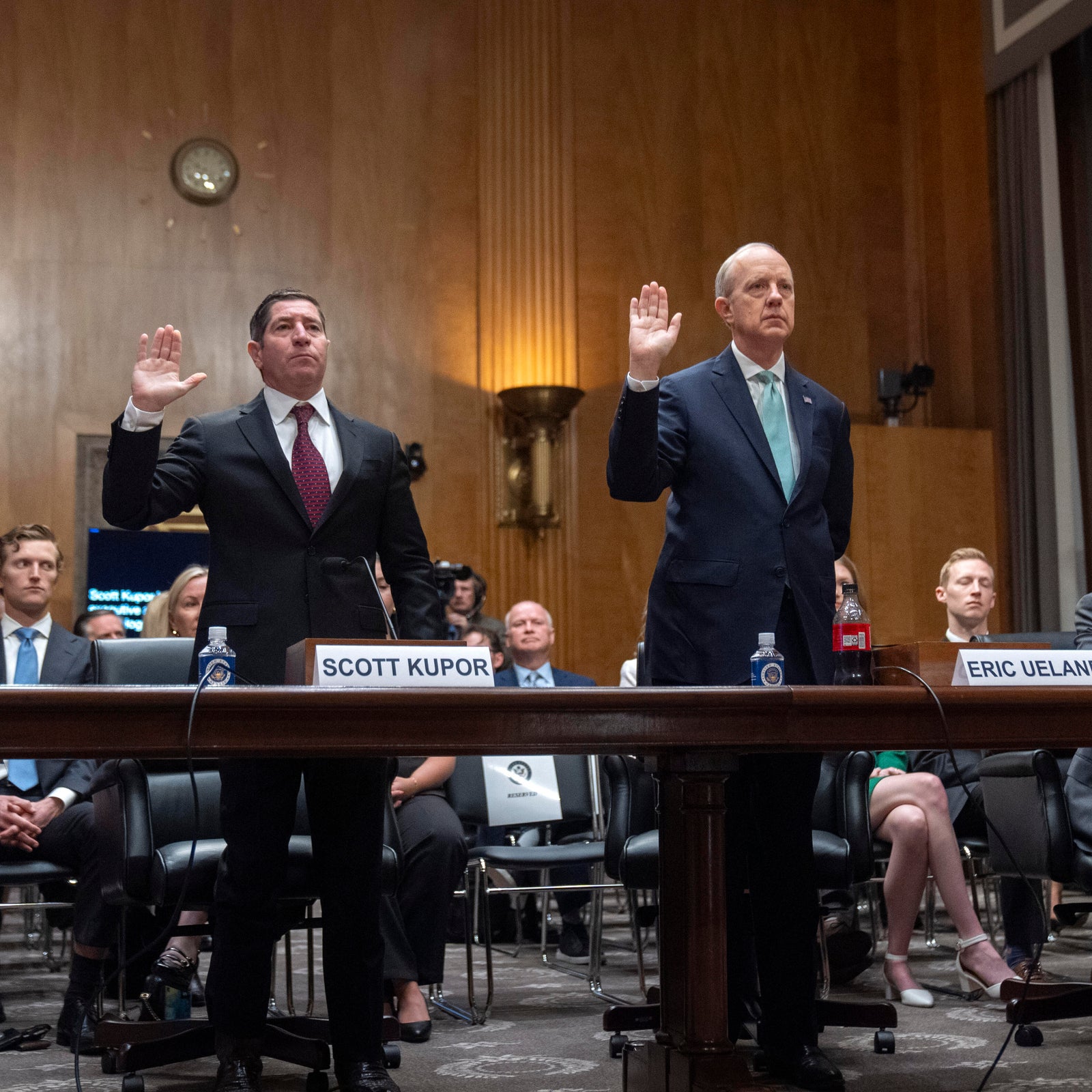 Scott Kupor, left, President Trump's pick to be director of the Office of Personnel Management, and deputy Eric Ueland, right, are sworn in during a Senate hearing on April 3, 2025.