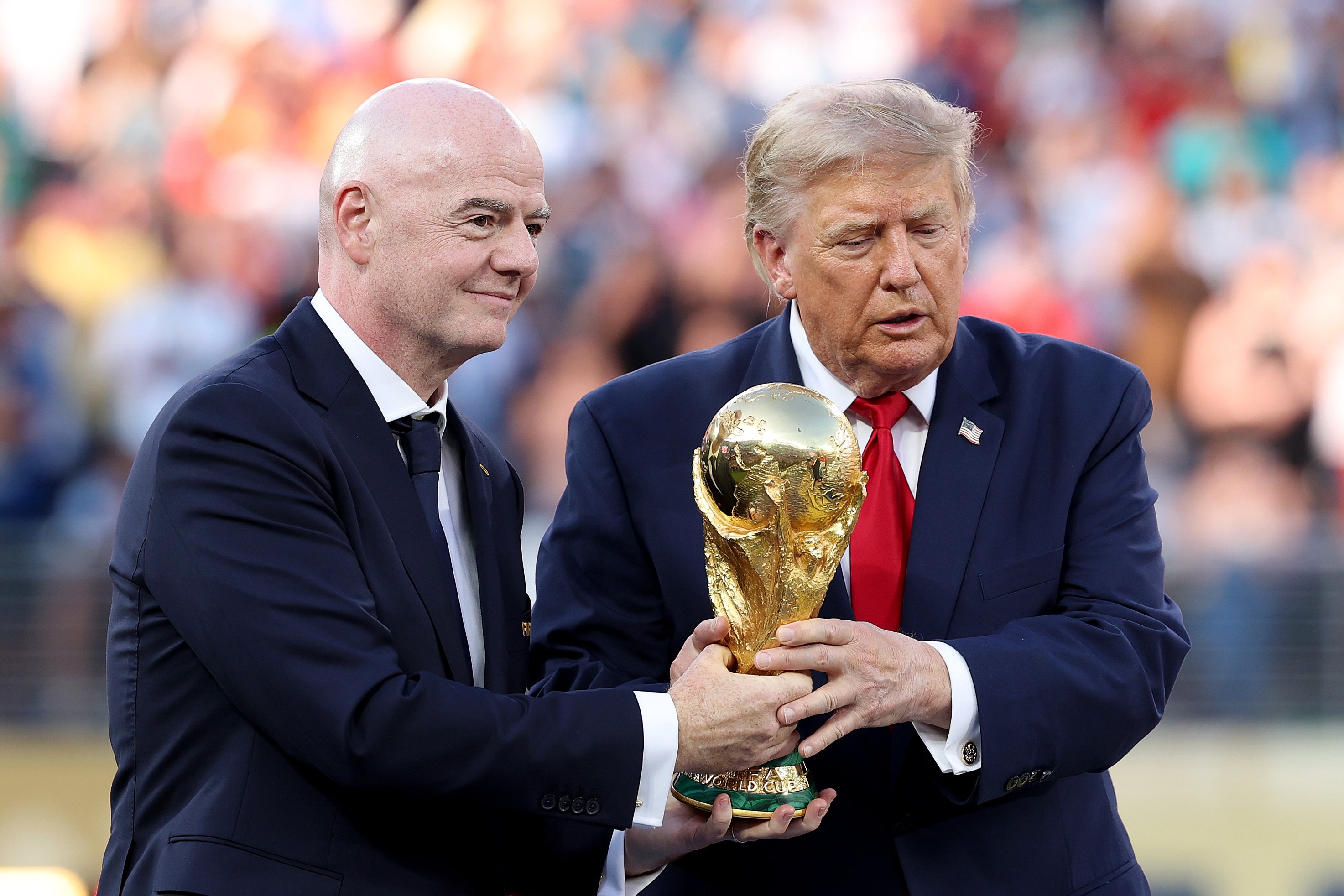Trump handed over the World Cup trophy to the Spanish team alongside FIFA President Gianni Infantino on Sunday (Getty)