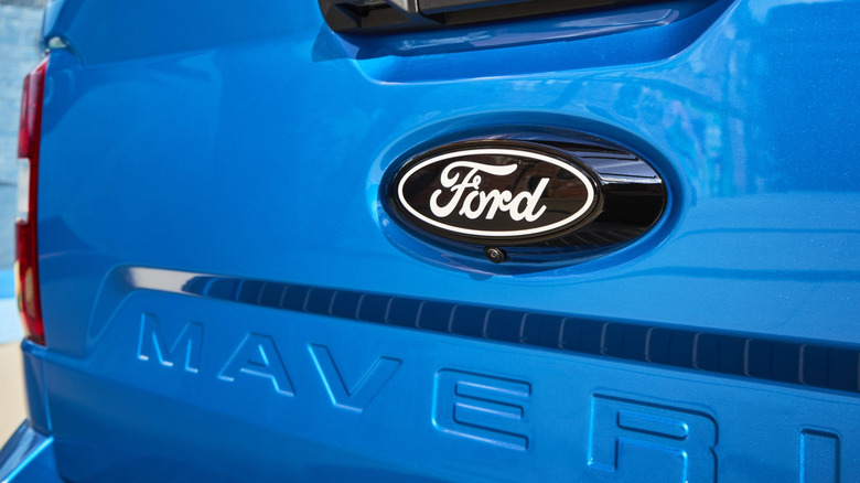 Close up view of Ford logo on blue Ford Maverick tailgate.
