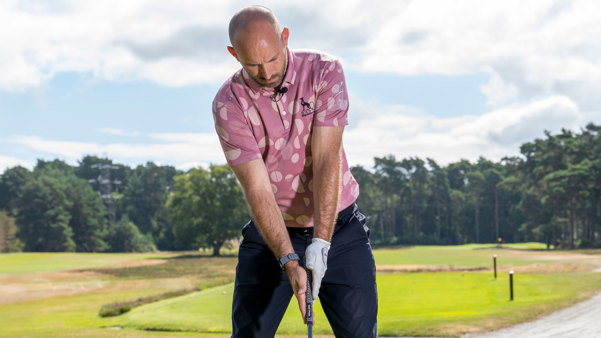 A golfer tilting his spine away from the target with driver