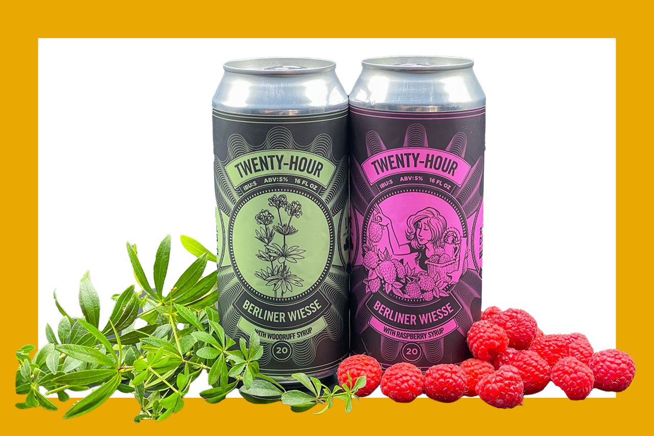 Two cans of TwentyHour Berliner Weisse beer with raspberries and greenery placed in front of them