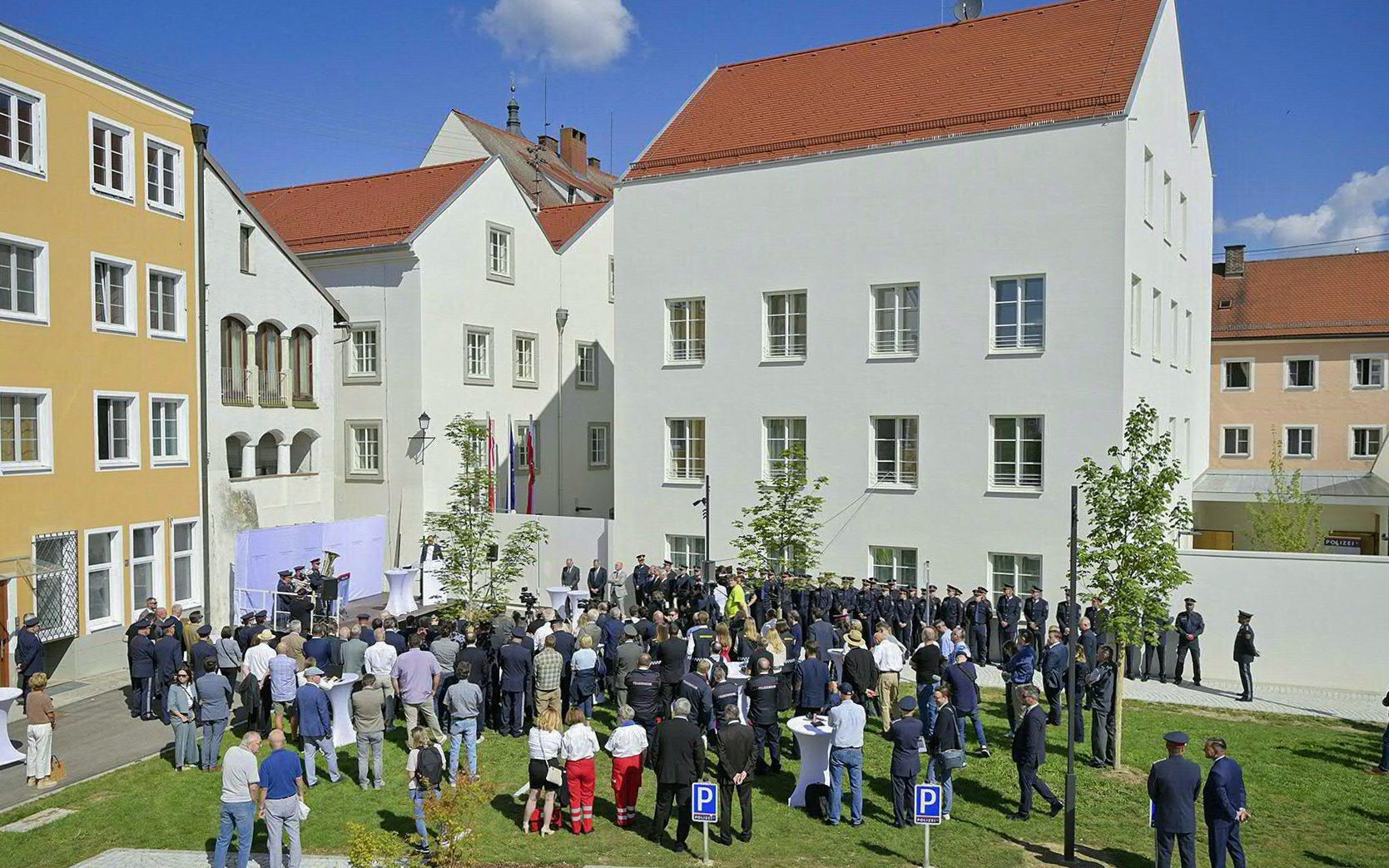Police officers and guests attend an inauguration ceremony in the courtyard of the birth house of Adolf Hitler that is turned into a police station