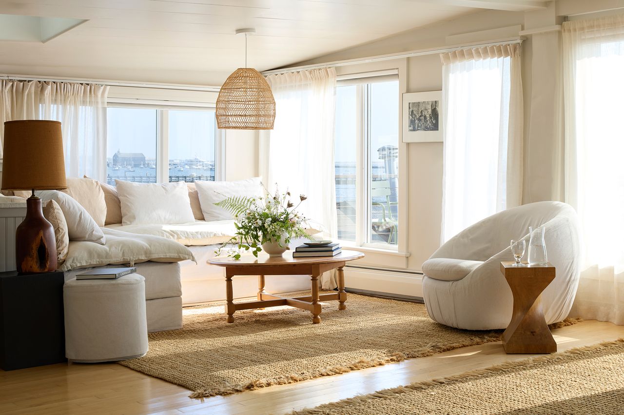 Stylish living room with furniture and large windows overlooking a landscape