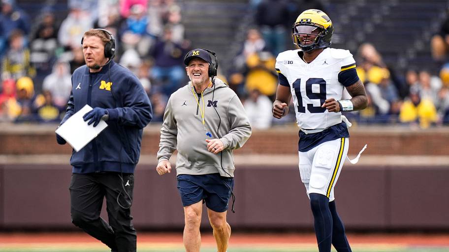 Michigan offensive coordinator Jason Beck, left, head coach Kyle Whittingham, center, and quarterback Bryce Underwood