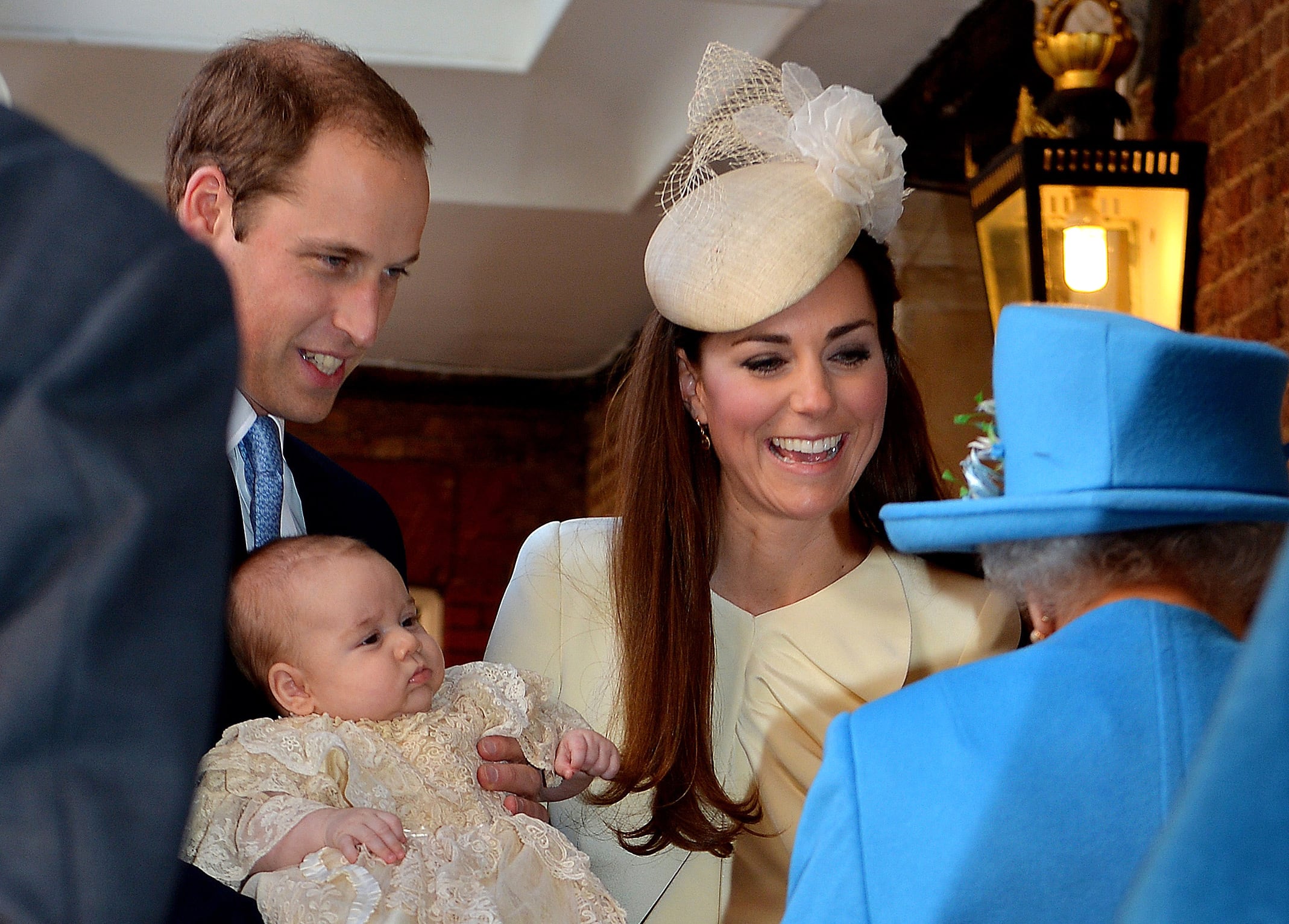 2013: Britain's Prince William, Duke of Cambridge and his wife Catherine, Duchess of Cambridge, speak with Queen Elizabeth II as they hold their son Prince George of Cambridge at Chapel Royal in St James's Palace in central London on October 23, 2013, upon arrival for the christening of the 3-month-old prince.