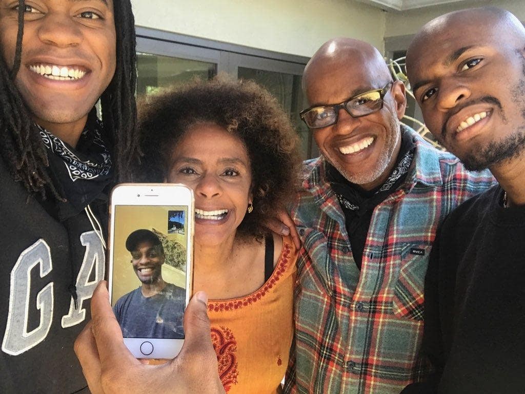 Jubilant Sykes and his family smile during a video call.