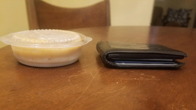 A portion of mashed potato placed next to a wallet