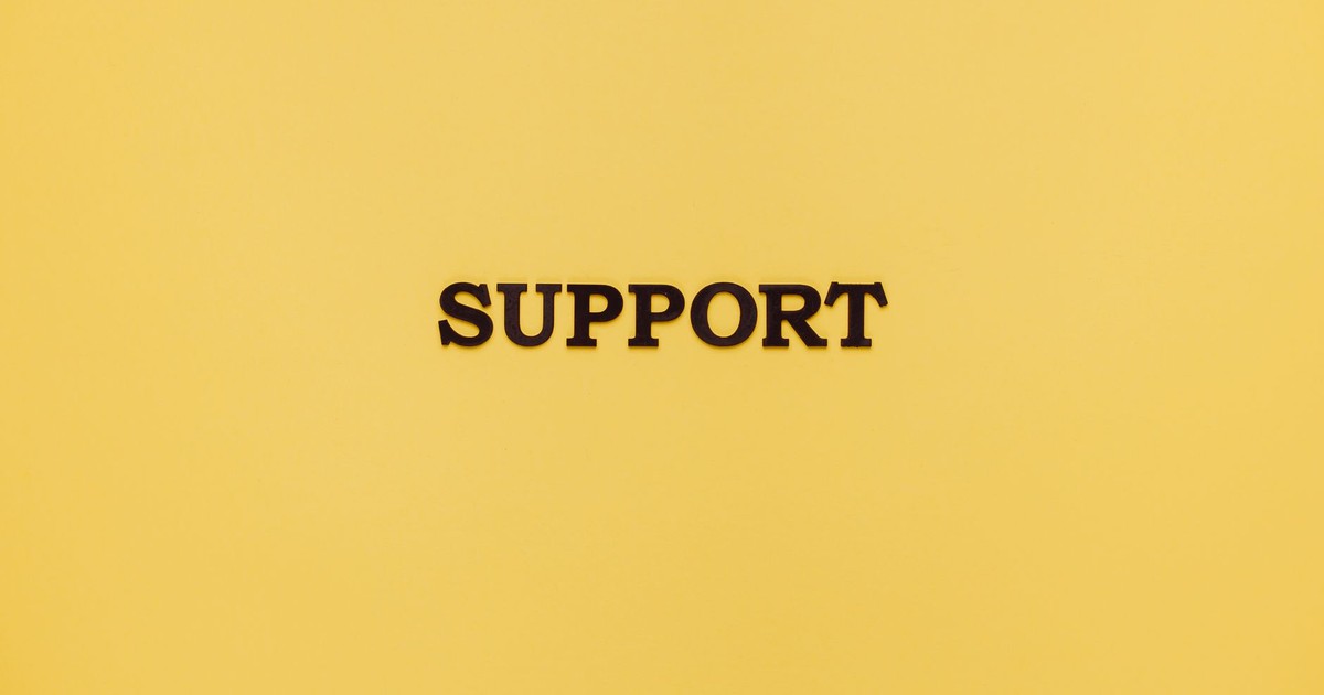 Minimalist image with 'Support' text on a yellow background for conceptual themes.