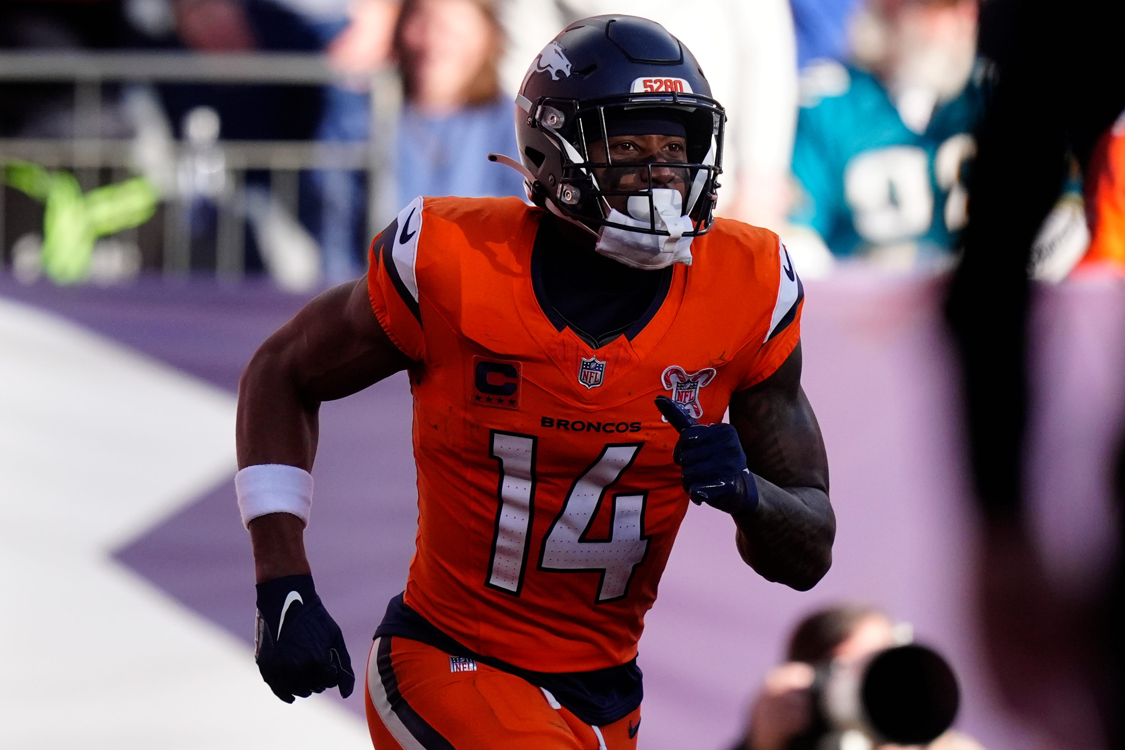 Dec 21, 2025; Denver, Colorado, USA; Denver Broncos wide receiver Courtland Sutton (14) reacts after scoring a touchdown against the Jacksonville Jaguars during the first half at Empower Field at Mile High. Mandatory Credit: Ron Chenoy-Imagn Images