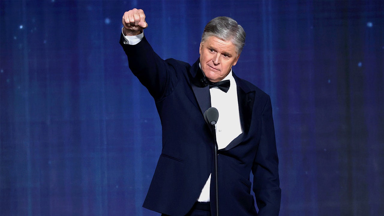Sean Hannity raises his fist while on stage at Fox Nation’s Patriot Awards ceremony.