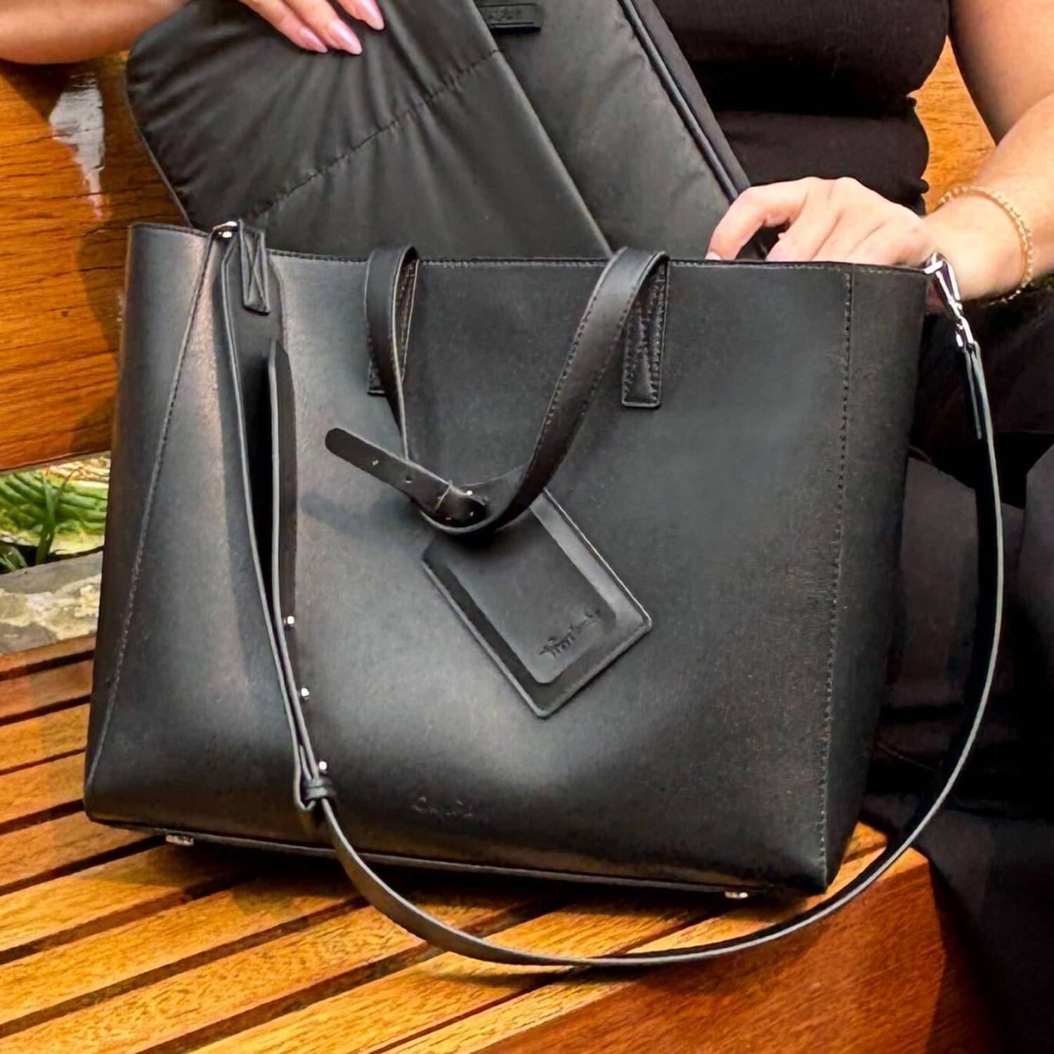 Woman sitting with the Haven Laptop Tote on her right side. (Daaiyah James / NBC News)
