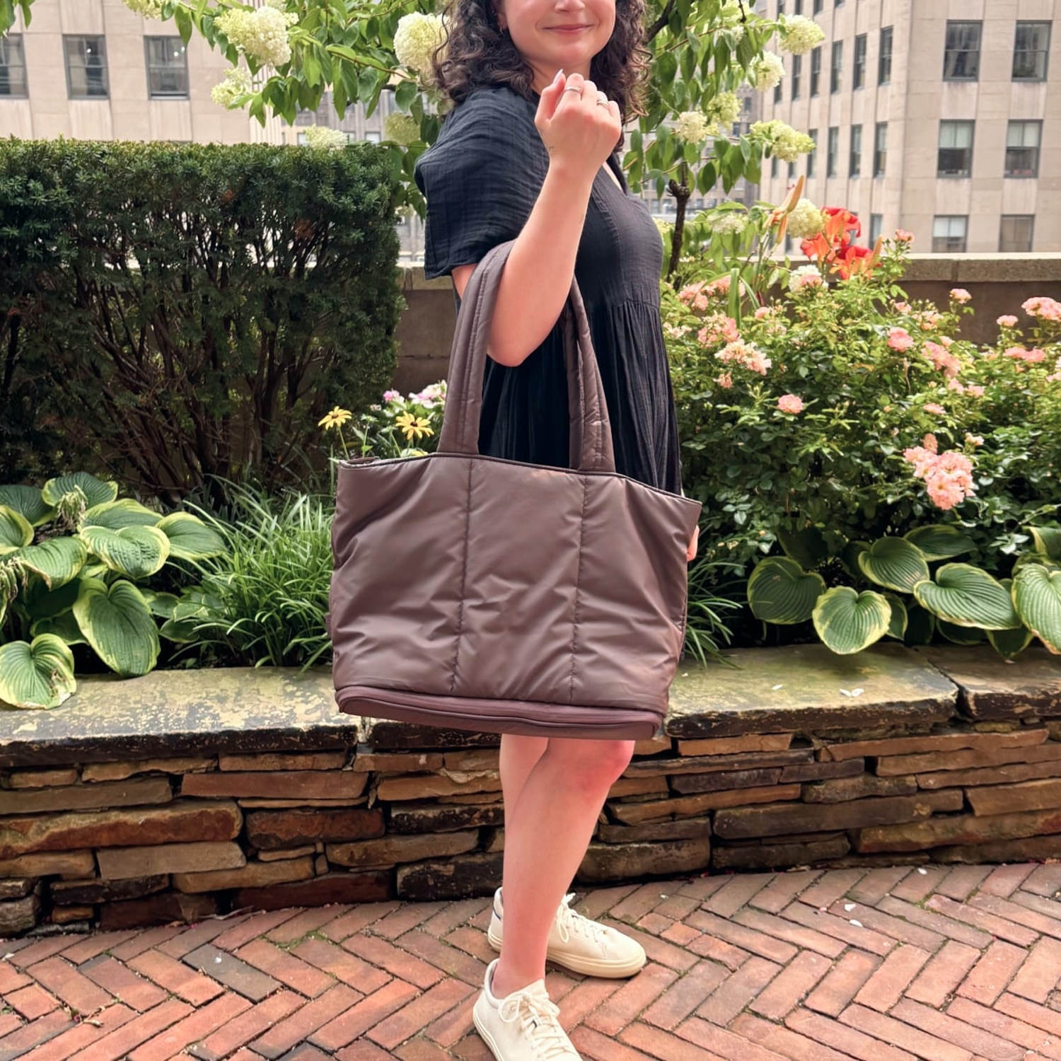Woman holding the Luka Expandable Tote on right arm. (Daaiyah James / NBC News)