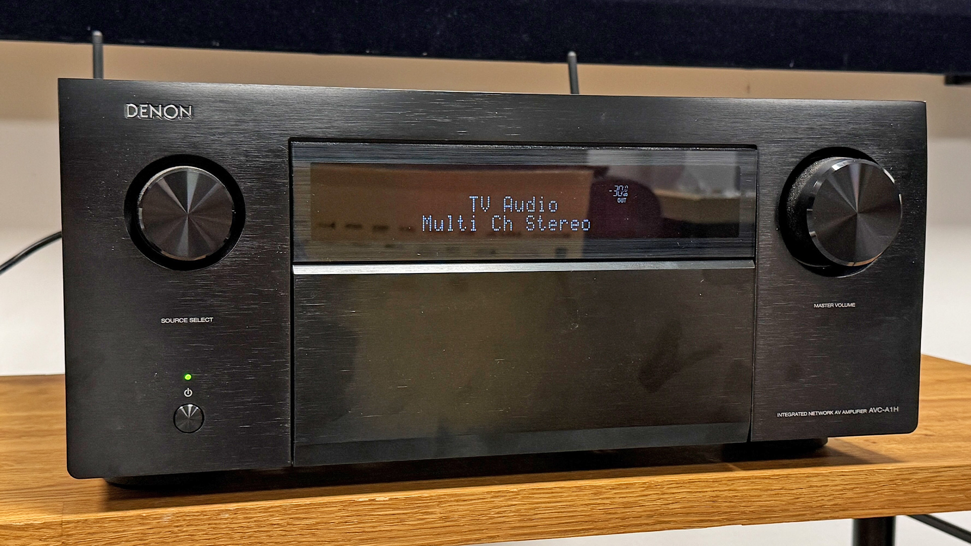 Denon AVC-A1H AV amplifier on wooden AV rack