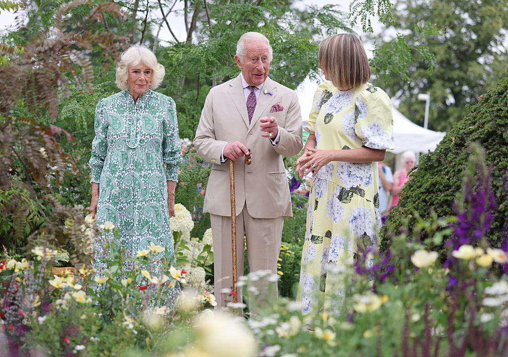 SANDRINGHAM, NORFOLK - JULY 22: Queen Camilla (L) and King Charles III speak with garden designer Catherine MacDonald as they visit the Royal Legacy Garden at the first RHS Sandringham Flower Show at Royal Sandringham Estate on July 22, 2026 in Sandringham, Norfolk. The event was the first Royal Horticultural Society (RHS) show to be held at Sandringham Estate. (Photo by Chris Jackson/Getty Images)