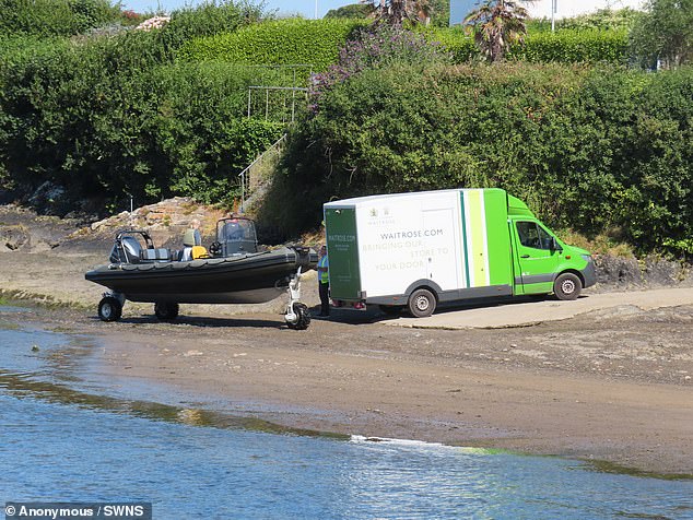 The Waitrose home delivery van had backed up onto the shore near Abersoch Harbour Beach,