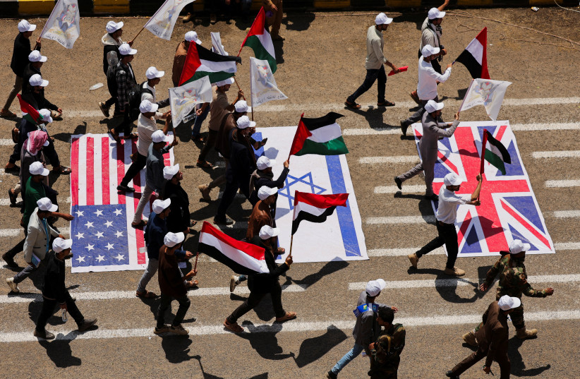 Students walk on U.S., Israeli and U.K. flags as they parade at Sanaa University campus to show support for the Houthis amid an escalation with Saudi Arabia, in Sanaa, Yemen, July 22, 2026. (credit: KHALED ABDULLAH/REUTERS)