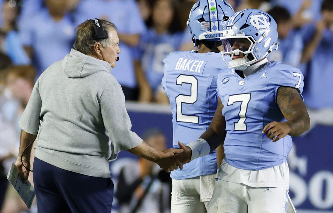 North Carolina head coach Bill Belichick congratulates quarterback Gio Lopez (7) after the Tar Heels scored in the first half of UNC’s game against TCU at Kenan Stadium in Chapel Hill, N.C., Monday, Sept. 1, 2025.
