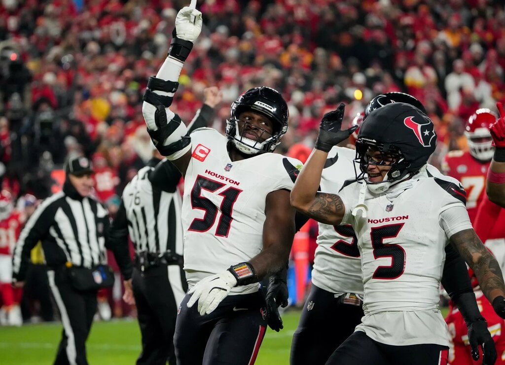 Dec 7, 2025; Kansas City, Missouri, USA; Houston Texans defensive end Will Anderson Jr. (51) and Houston Texans safety Jalen Pitre (5) celebrate after sacking Kansas City Chiefs quarterback Patrick Mahomes (15) during the first quarter at GEHA Field at Arrowhead Stadium. Mandatory Credit: Denny Medley-Imagn Images