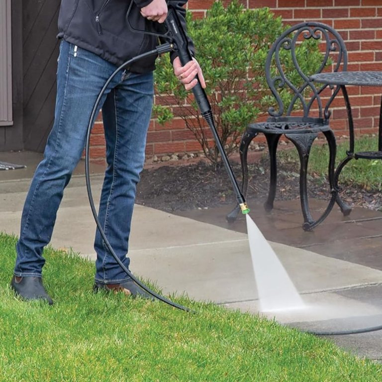 A person using the Westinghouse ePX3050 electric pressure washer to clean a front walkway to enhance curb appeal