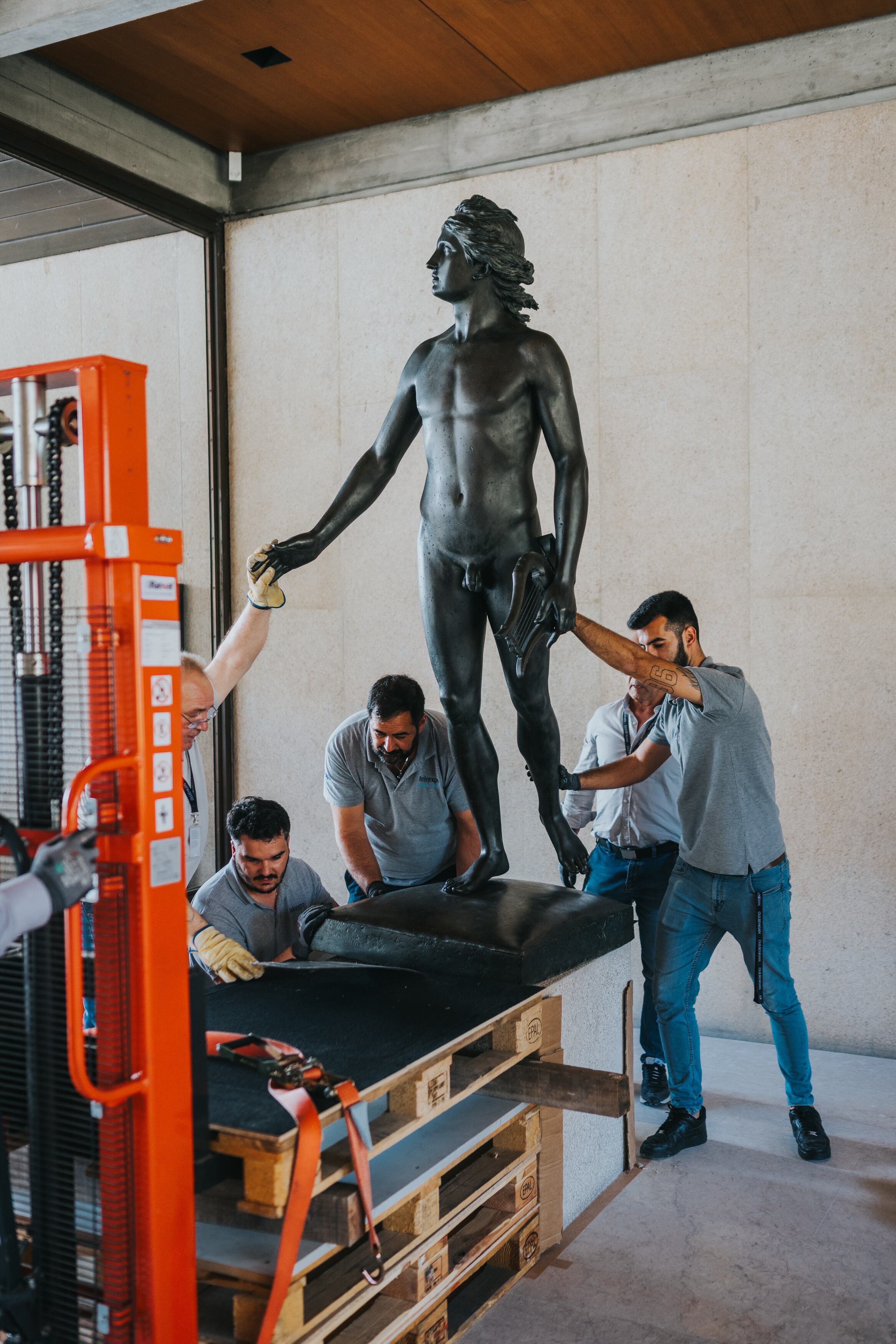 Workers place a statue following the restoration of the museum.