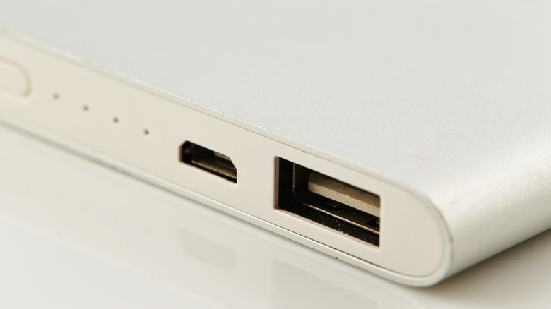 A close up shot of a white power bank on a white surface
