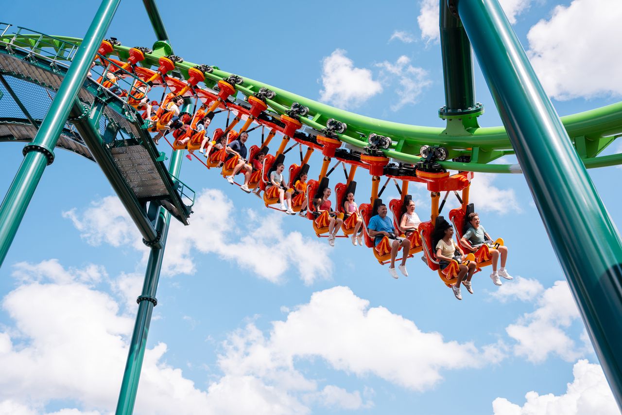 People riding a looping roller coaster