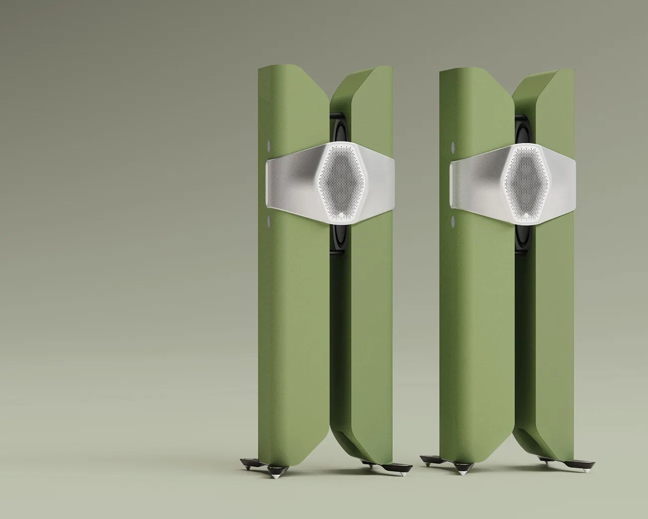 Pair of tall, green floor-standing speakers with silver hexagonal central grills on a light green background.