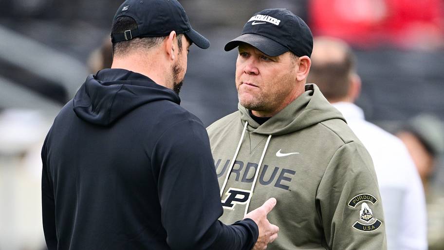 Purdue Boilermakers head coach Barry Odom speaks with Ohio State Buckeyes head coach Ryan Day.