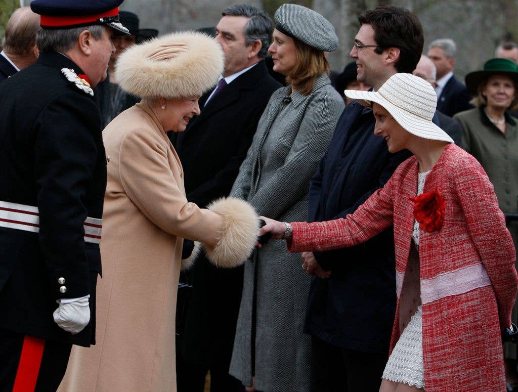 Marie rocked a white mini dress and red tweed coat for the occasion