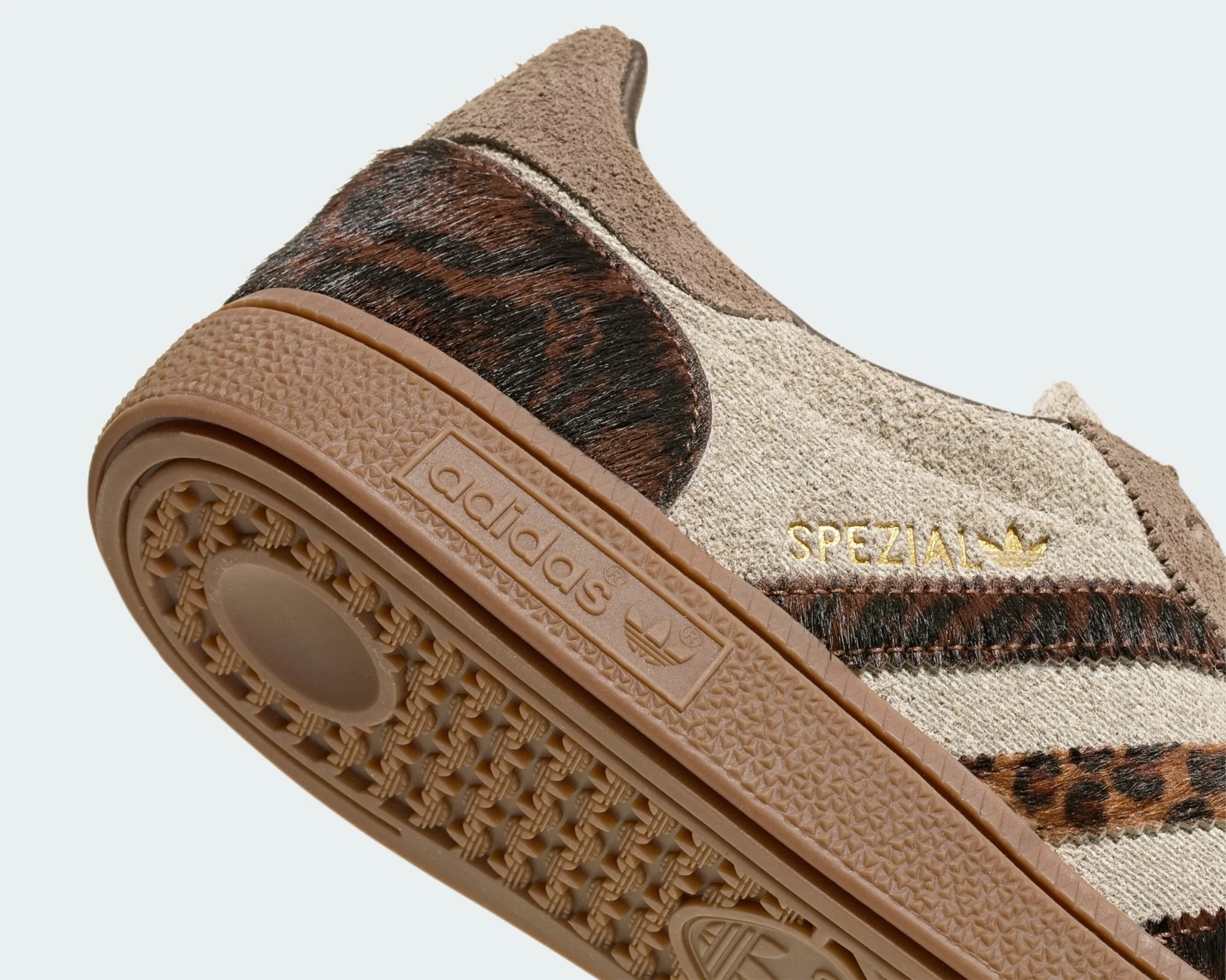 Close-up of the heel and sole of an Adidas Spezial sneaker with beige suede, brown leopard print, and gum rubber sole.