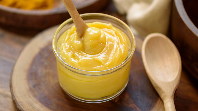 A glass jar of bright yellow ghee