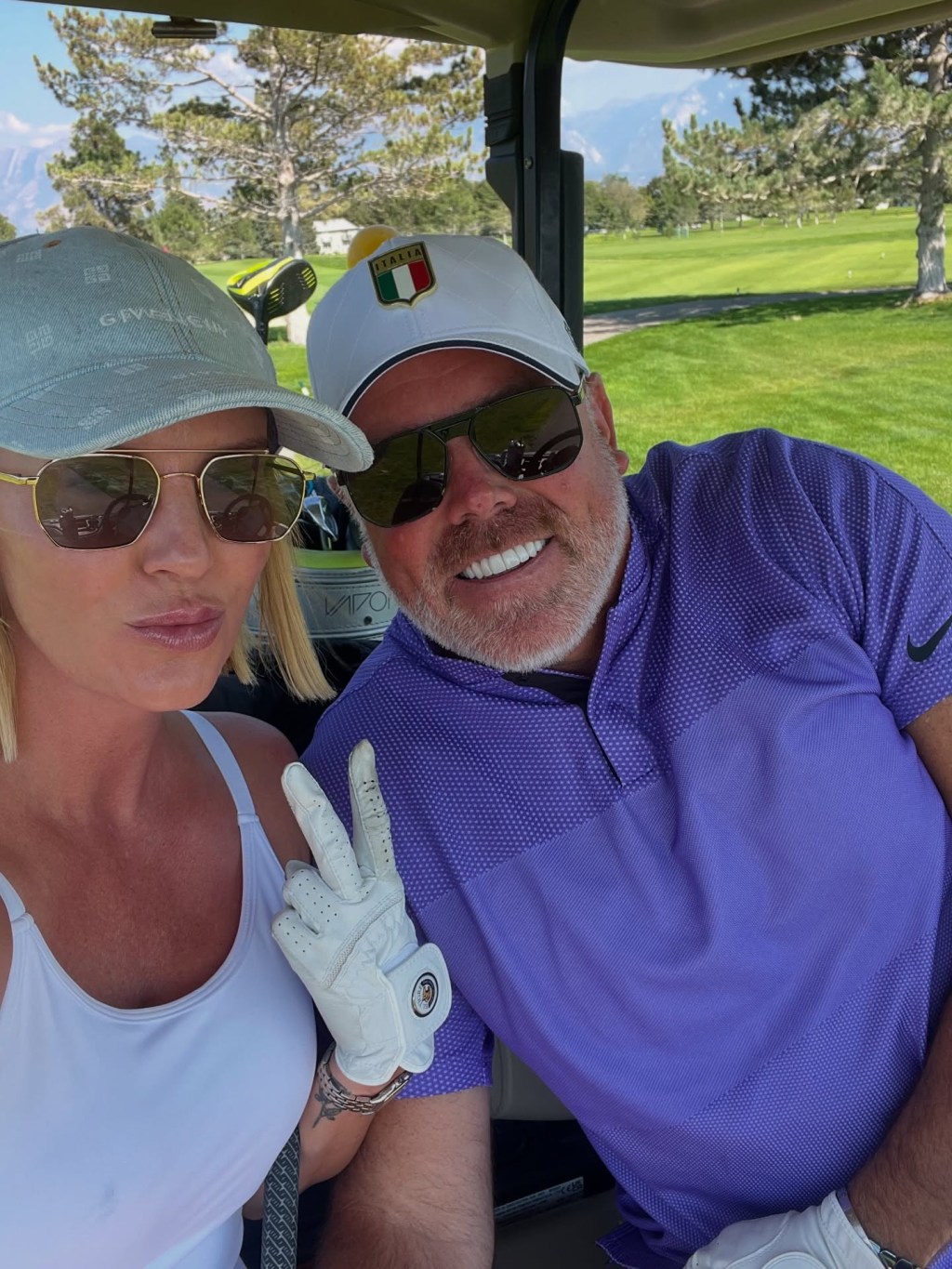 Whitney and Justin Rose in a golf cart.