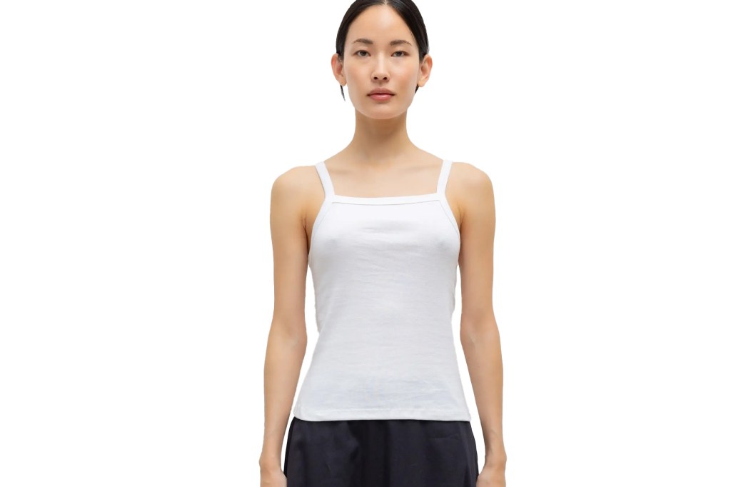 A model wearing a white tank top.