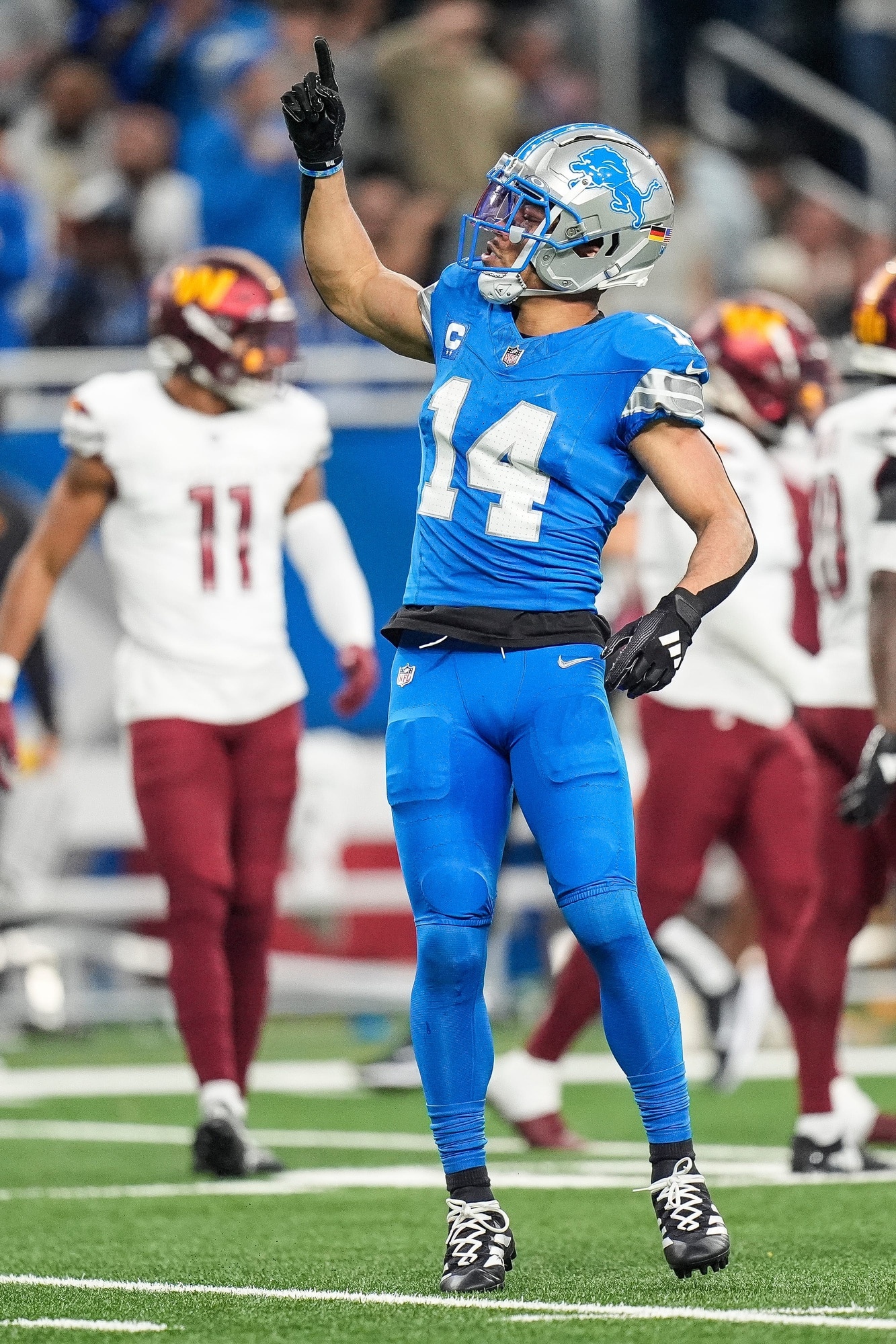 Detroit Lions wide receiver Amon-Ra St. Brown (14) celebrates a first down against Washington Commanders during the first half of the NFC divisional round at Ford Field in Detroit on Saturday, Jan. 18, 2025.
