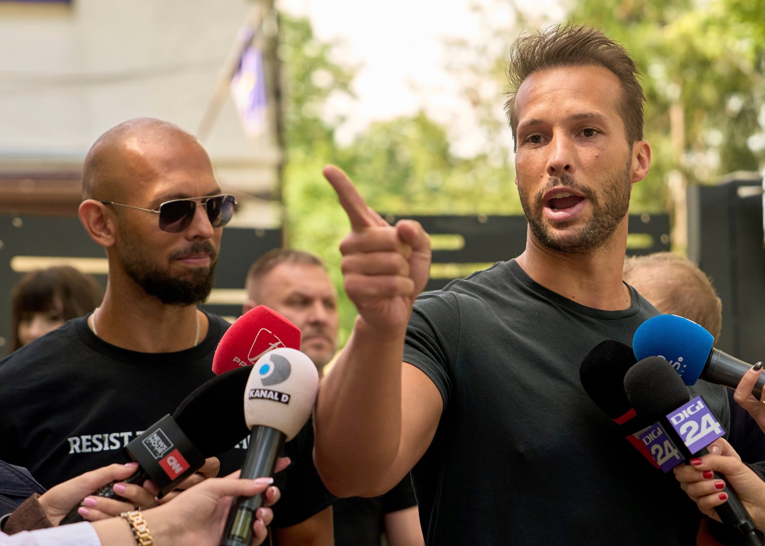 Andrew Tate, left, and his brother Tristan are currently being held in federal custody (Vadim Ghirda/AP)