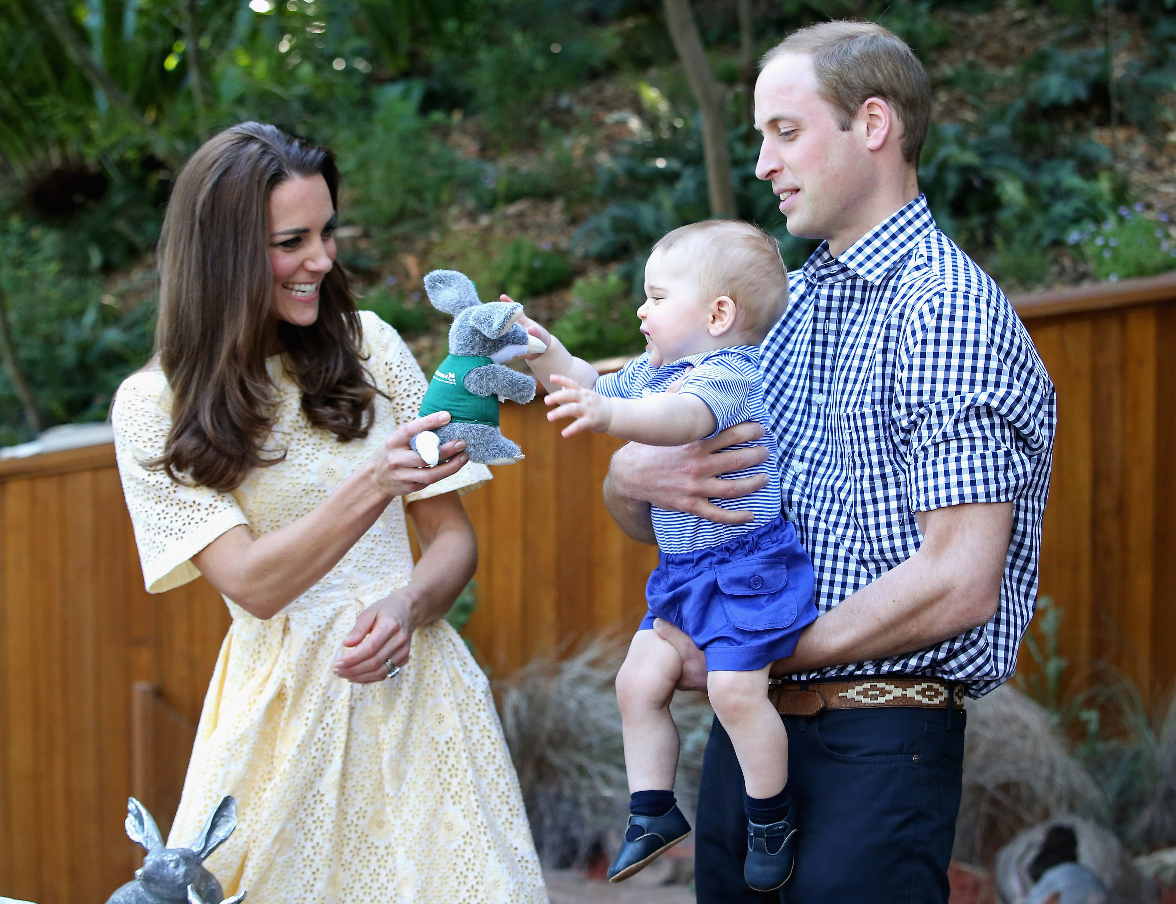 2014: Prince William, Duke of Cambridge, holds Prince George of Cambridge as Catherine, Duchess of Cambridge, gives him a toy bilby during a visit to the Bilby Enclosure at Taronga Zoo on April 20, 2014, in Sydney, Australia.