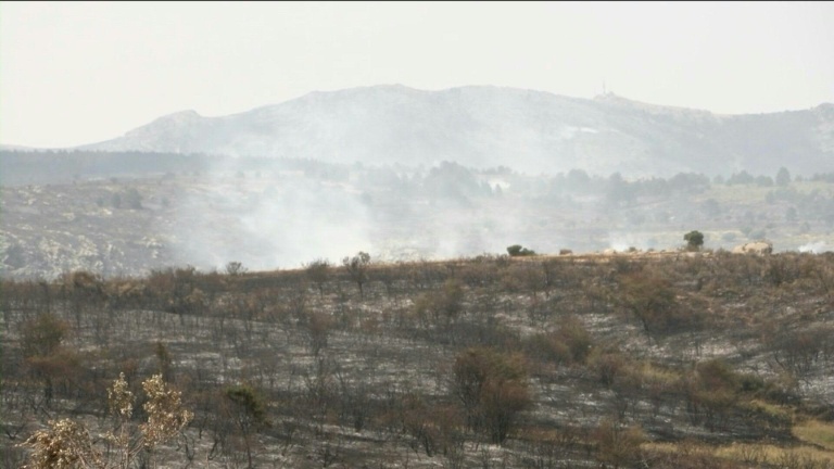 Smoke rises from burnt landscape as Spain wildfire rages